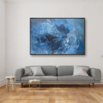 Blue abstract painting, original oil painting on canvas hanging in a modern living room with a gray sofa
