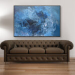 Blue abstract painting, original oil painting on canvas hanging in a modern living room with a brown sofa