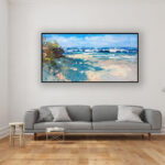 Beach painting, original oil painting on canvas hanging in a modern living room with a gray sofa